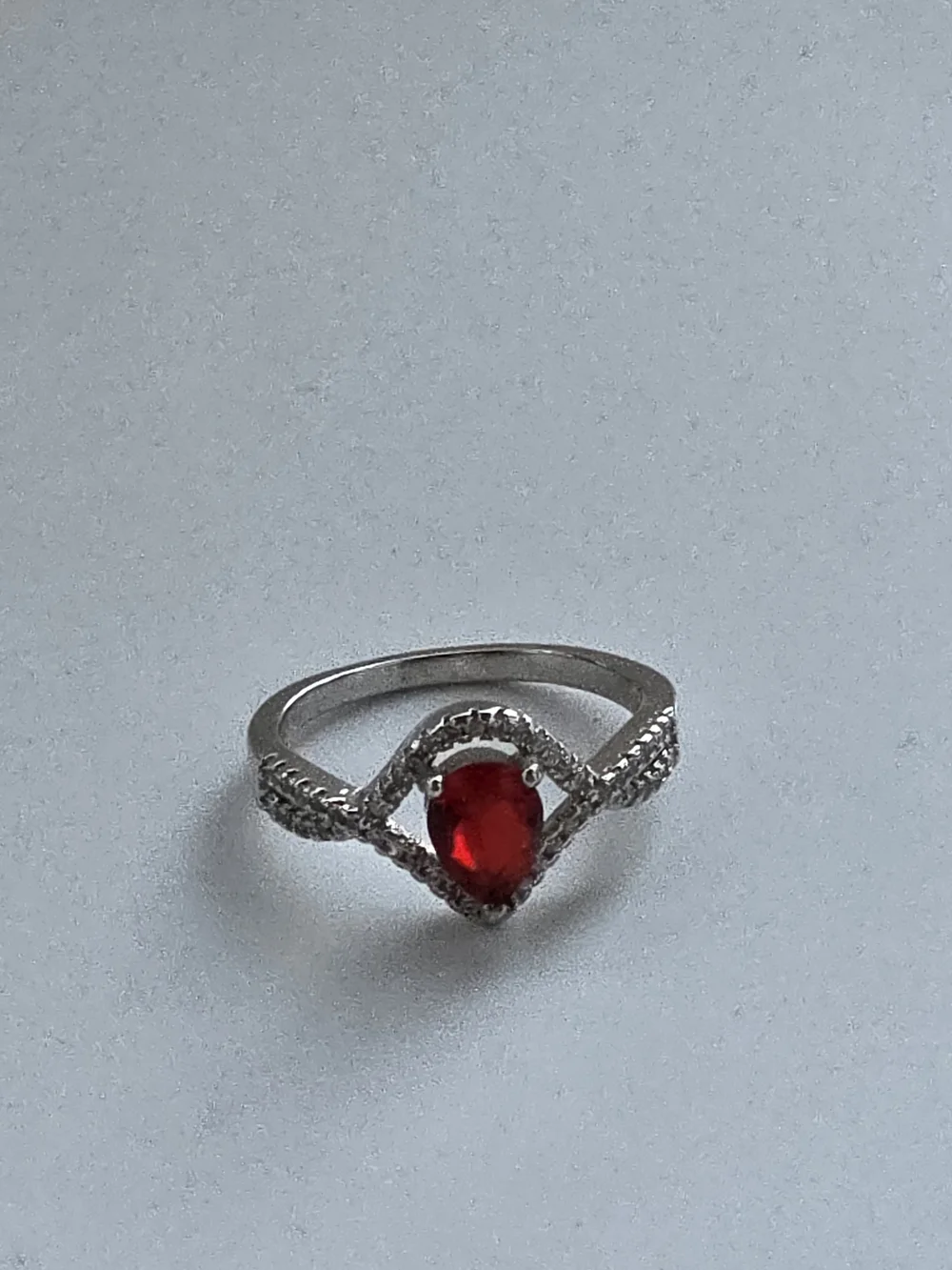 Sterling-Inspired Silver Ring with Pear-Shaped Red Gem and Pavé Halo